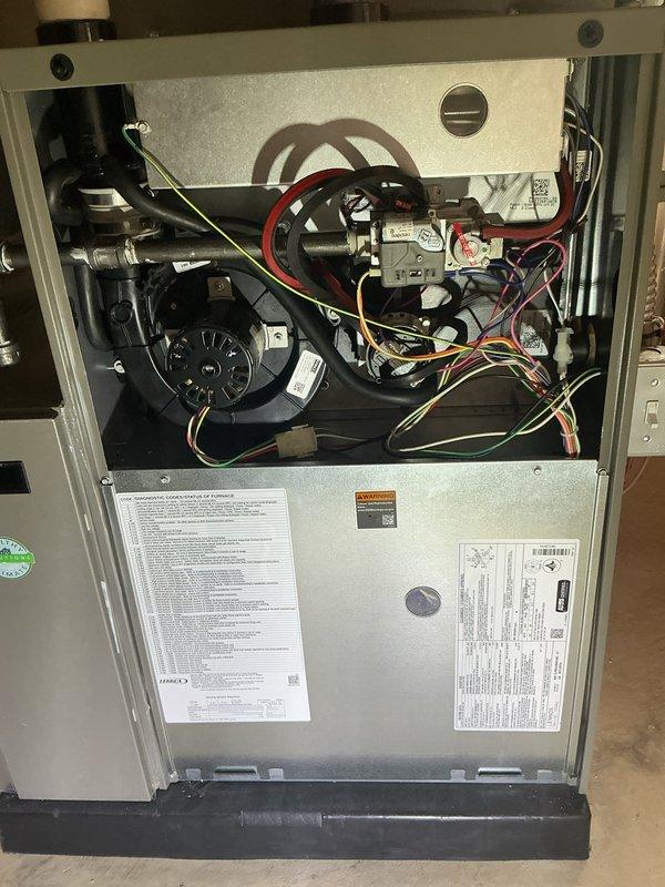 Technician responded to service call and performed diagnostic evaluation of heating unit. Upon inspection, discovered failed heat exchanger requiring replacement. Removed access panels to assess internal components and document condition. Verified unit was under full warranty coverage. Ordered replacement heat exchanger (part #11X42) from Lennox supply house for warranty replacement. Photographed internal components including blower assembly, gas valve, electrical connections, and wiring configuration for documentation purposes. Unit taken out of service pending heat exchanger replacement under manufacturer's full warranty program.