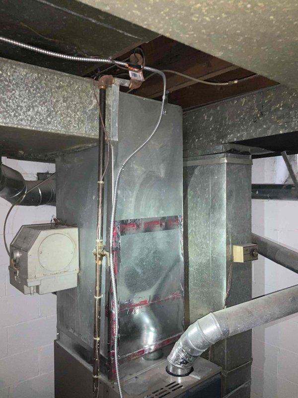 Conducted on-site evaluation for central air conditioning system installation in residential property. Assessed existing HVAC infrastructure in basement mechanical room, including aged air handler unit with oxidation present and associated ductwork connections. Documented current equipment configuration, including flexible ductwork routing, control components, and AO Smith water heater installation to determine optimal placement and compatibility for new central AC system. Provided comprehensive replacement estimate for complete air conditioning unit installation to meet customer's requested timeline of within one month.