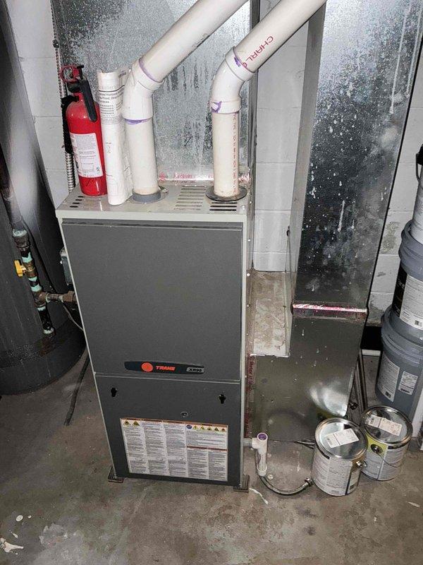 Completed estimate for replacement of 12-year-old furnace and installation of new air conditioning system at residential property currently without AC. Assessed existing Trane furnace unit in basement utility area and evaluated exterior wall space for outdoor condenser placement. Documented current HVAC configuration including PVC venting system and available electrical infrastructure to provide comprehensive replacement quote for complete heating and cooling system upgrade.