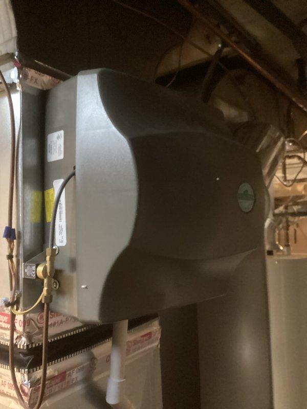 Completed full HVAC system installation including a 110,000 BTU furnace, 4-ton air conditioning unit with rear discharge configuration, whole-home humidifier, and hot water heater with liner in basement utility room. All copper refrigerant lines, PVC condensate drainage, gas connections, and electrical hookups were professionally installed and tested. System was fully commissioned with all equipment operational and permits obtained prior to installation.