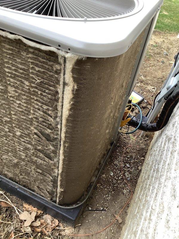 Performed routine Air Care Maintenance on outdoor condensing unit that exhibited heavy accumulation of dirt, dust, and environmental debris on exterior panels and internal mesh screens. Cleaned condenser coils and air intake screens which were significantly clogged with grayish-brown material that was restricting proper airflow and reducing system efficiency. Unit was restored to optimal operating condition and all components inspected for proper function.