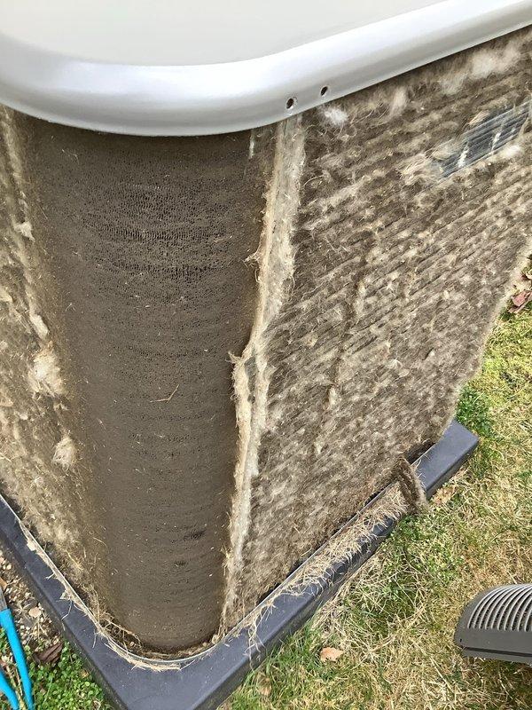 Performed routine Air Care Maintenance on outdoor condensing unit that exhibited heavy accumulation of dirt, dust, and environmental debris on exterior panels and internal mesh screens. Cleaned condenser coils and air intake screens which were significantly clogged with grayish-brown material that was restricting proper airflow and reducing system efficiency. Unit was restored to optimal operating condition and all components inspected for proper function.