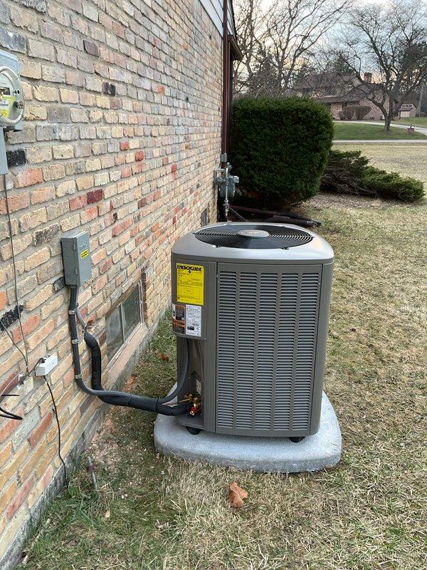 Completed full HVAC system installation including 90,000 BTU gas furnace with left-side configuration, 3.5 ton air conditioning condenser unit, and whole-home humidifier. Installed outdoor AC condenser on concrete pad against brick exterior with proper refrigerant line routing and secure mounting brackets. Ran new dedicated electrical circuit and installed disconnect box to meet code requirements. Positioned furnace/air handler in basement utility area with proper clearances and connected to existing ductwork infrastructure. Installed white PVC condensate drainage lines and venting per manufacturer specifications. Secured all refrigerant lines, electrical conduit, and mechanical connections. Verified system startup, checked refrigerant charge levels, tested all safety controls, and confirmed proper airflow throughout duct system. All mechanical and electrical permits obtained and installation completed to code compliance standards.