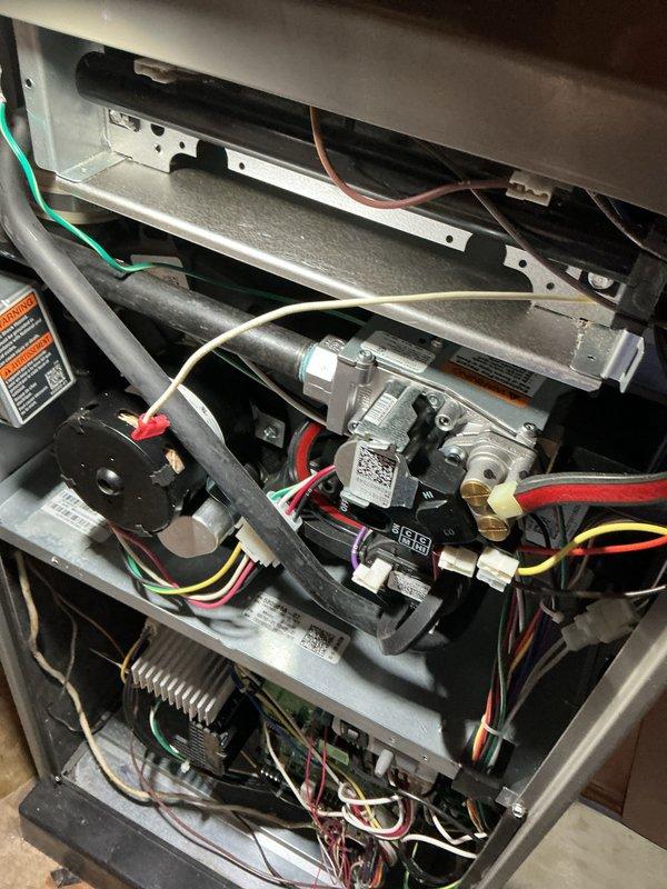 Completed scheduled AHC maintenance on HVAC system, performing comprehensive inspection of heating and cooling components. Documented internal mechanical assemblies including blower motor, gas valve assembly, ignition module, control board, wiring harnesses, and heat exchanger with photographic records. Unit requires replacement evaporative cooler pads for optimal cooling season performance.