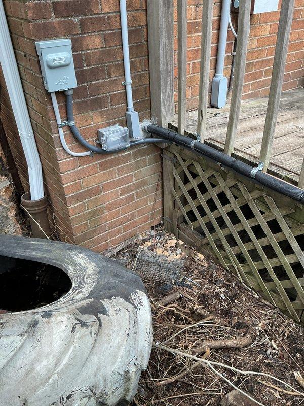 Completed installation of 2.5-ton Lennox air conditioning system with matching evaporator coil at residential property. Installed outdoor condenser unit on ground pad in side yard area adjacent to brick exterior wall. Ran refrigerant linesets and electrical conduit along exterior brick wall to connect outdoor unit to indoor coil. Installed electrical disconnect box and completed electrical connections to existing 100-amp service panel. Secured all refrigerant lines and electrical conduit to brick wall with proper mounting straps. Verified all electrical connections meet code requirements for mechanical and electrical permits. System installation completed per specifications with rear placement configuration. All components properly mounted and secured for operational readiness.