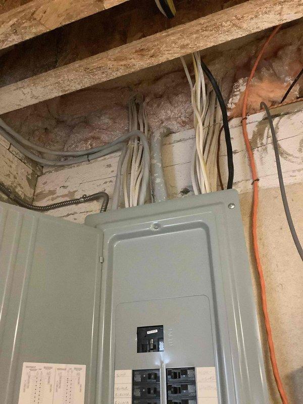 Conducted on-site evaluation for new whole-home Kohler generator installation. Assessed existing electrical service panel location on exterior brick wall with current conduit routing, and inspected interior main electrical panel in basement to determine integration requirements for automatic transfer switch installation.