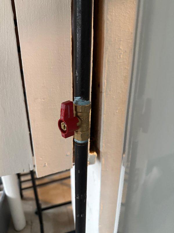 Successfully installed a 40-gallon tanked water heater in residential utility area. Installation included proper copper piping connections, shut-off valve with accessible red handle for emergency water control, and vented burner compartment assembly. Mechanical permit obtained and all work completed to code specifications.