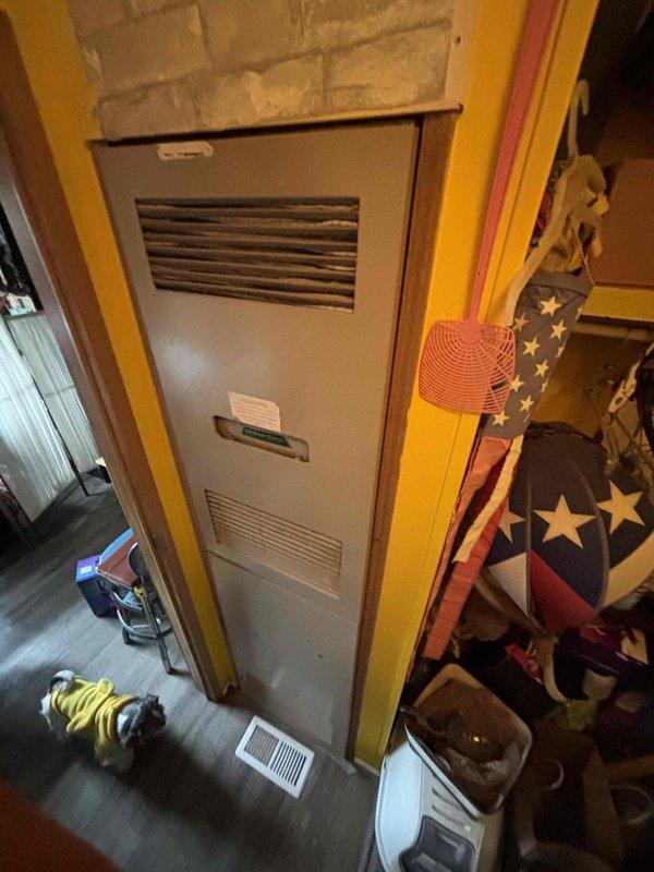 Completed estimate appointment for replacement of 33-year-old gas furnace in mobile home installation. Evaluated existing vertical furnace unit and outdoor condensing unit, documented current system configuration and condition through photographs. Provided equipment replacement options and discussed available furnace/AC promotion package with property owner.