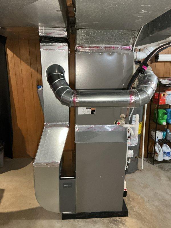 Completed installation of 90,000 BTU residential furnace unit with all required mechanical and electrical connections. Installed new PVC intake and exhaust venting through exterior brick wall, configured supply plenum with insulated ductwork, and reconnected system to existing distribution network. All necessary permits obtained and installation performed to code specifications.