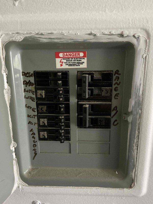 Conducted in-home estimate for complete HVAC system replacement in condo unit with 21-year-old air conditioning and furnace equipment. Assessed existing beige metal HVAC unit located in basement utility room, documented electrical panel configuration with multiple circuit breakers, and photographed current system condition including unit placement, surrounding work area, and electrical infrastructure. Provided homeowner with replacement options and specifications for new system installation.