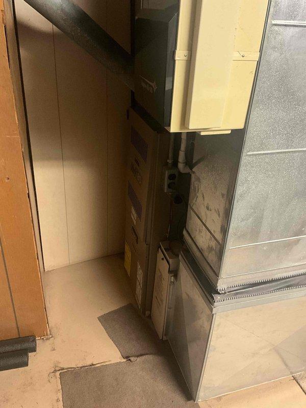 Provided estimate for complete HVAC system replacement including furnace and air conditioning unit under promotional offer. Existing 31-year-old natural gas furnace and AC system located in basement are currently operational but have exceeded their expected service life. Assessment included documentation of existing equipment configuration, condensate conditions on metal panels, copper refrigerant lines, and available clearances for new installation in the confined mechanical space.