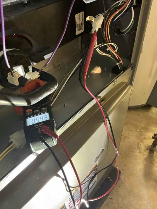 Completed annual HVAC maintenance inspection including replacement of furnace filter and humidifier pad as part of recurring Air Care Heating and Cooling service. Performed electrical diagnostics using multimeter to verify system operation, confirmed proper voltage readings at .548V on tested component, and inspected internal wiring connections and blower assembly. Verified thermostat functionality with system maintaining setpoint at 74°F and displaying accurate indoor temperature reading.