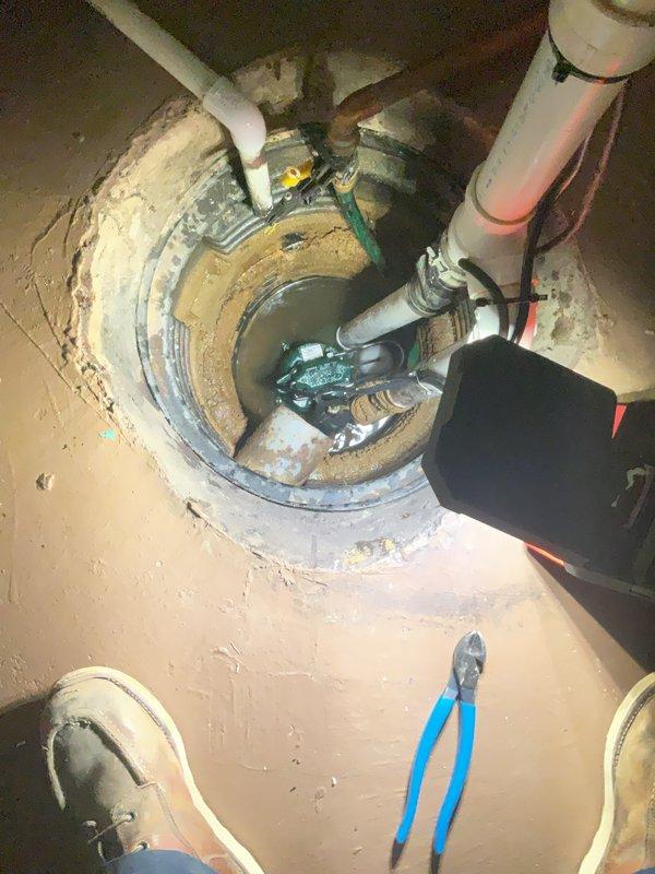 Installed a new M53-D submersible sump pump system with automatic float switch operation in existing basement sump basin. Connected discharge piping using white PVC with proper check valve installation to prevent backflow, secured all pipe connections with metal clamps, and verified vent hole placement for proper air circulation. Tested pump operation and float switch functionality to ensure automatic activation at appropriate water levels, confirmed proper drainage through discharge line, and left system fully operational with three-year manufacturer warranty coverage.