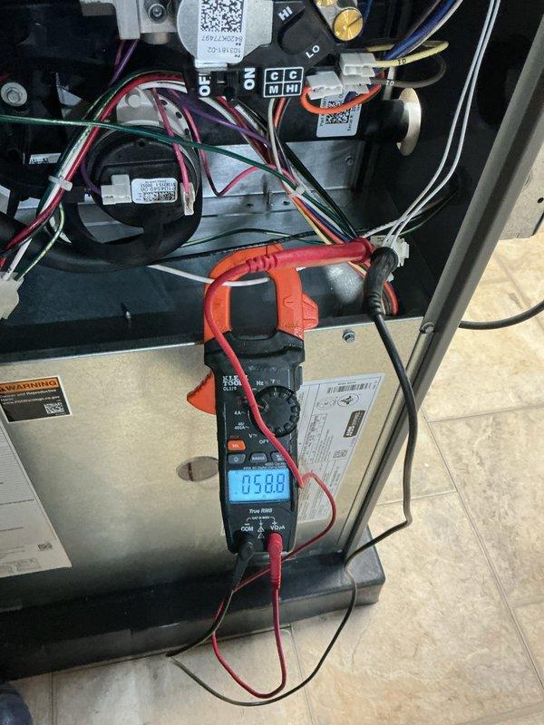 Completed comprehensive ComfortGuard maintenance inspection on residential HVAC system. Performed electrical diagnostics using clamp meter to verify proper amperage draw and system performance, inspected all internal electrical connections and wiring configurations, and confirmed thermostat operation and programming functionality. All components found operating within normal parameters with no issues identified during this routine maintenance visit.