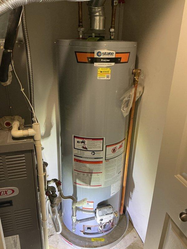 # Tanked Water Heater Leak Assessment

Responded to report of active water heater leak in residential utility closet. Upon arrival, inspected State brand 40-gallon natural gas water heater (Model GS6-40-BCI 400, manufactured 08/17/2020) and confirmed steady leak discharging into drain pan. Leak source isolated to tank body, indicating internal tank failure consistent with unit age and service life expectancy.

Documented equipment condition with photographs showing water heater installation, copper supply lines, gas connections, and manufacturer data plate with serial number 203312057734. Verified leak was contained to drain pan area with no water migration beyond immediate equipment location. Confirmed unit specifications: 40,000 BTU input, 42-gallon per hour recovery rate, natural gas fuel type.

Advised homeowner that active tank leak requires full water heater replacement as tank integrity cannot be restored through repair. Confirmed customer has active warranty coverage on water h
