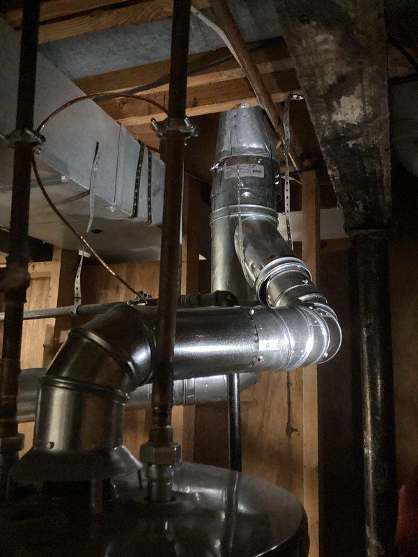 Completed full HVAC system installation including a 90,000 BTU furnace and 3-ton air conditioning unit with rear discharge configuration. Installed complete ductwork system with multiple 90-degree elbows and transitions to accommodate existing structural framing in basement utility area. Performed all necessary grounding and bonding connections, reconnected existing utilities, and secured all required mechanical and electrical permits for the installation.