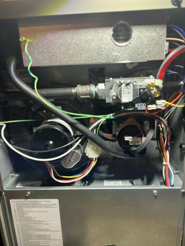 Completed annual furnace maintenance and tune-up on residential heating system. Performed comprehensive inspection of gas valve assembly, pressure switch, burner components, and all electrical connections. Verified proper operation of blower motor, confirmed all wire harnesses secure, checked gas line connections for leaks, and tested safety controls. All components found operating within manufacturer specifications with no issues detected. System photographed and left in proper working condition.