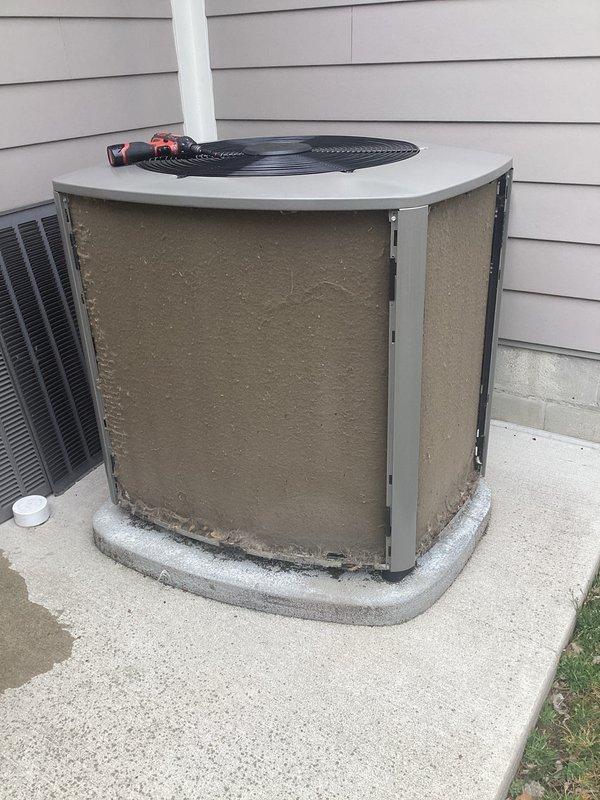 # HVAC Annual Maintenance Completed

Performed comprehensive annual heating and cooling maintenance on residential split system. Inspected outdoor condenser unit and found heavy accumulation of dust, debris, and dark staining on evaporator coils and metal fins. Cleaned condenser coils thoroughly to restore proper airflow and heat transfer efficiency. Checked refrigerant lines and service valves; confirmed proper connections with valve caps intact. Verified condenser fan operation and inspected electrical components including wiring connections. Unit positioned on concrete pad with adequate clearance from building. Documented equipment condition with photos showing before cleaning status. System operational upon completion of maintenance service.