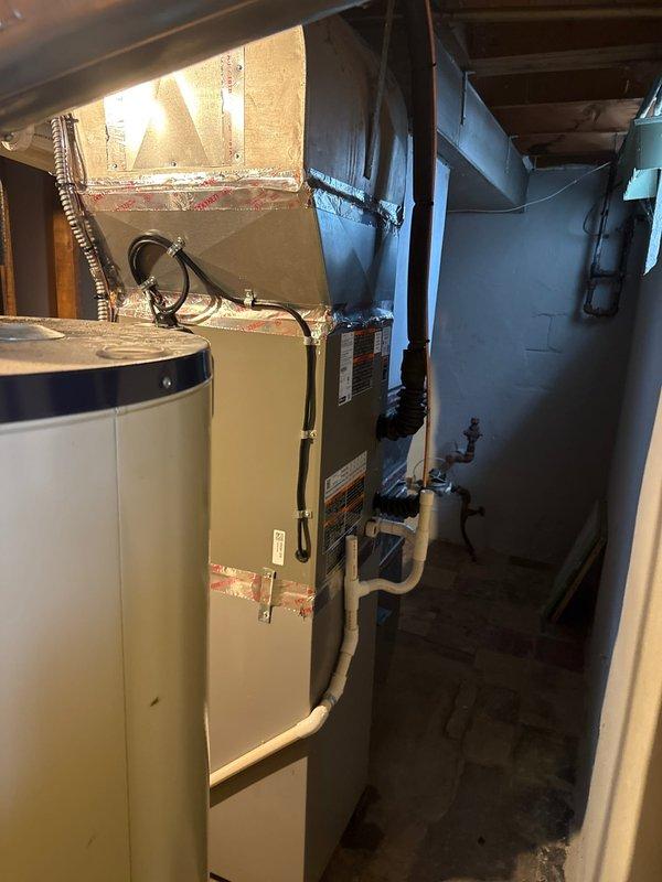 Completed installation of 2.5-ton air conditioning system with matching evaporator coil in basement utility area. Unit positioned at rear of property with reconnection to existing electrical service. Mechanical and electrical permits obtained prior to installation, and all work performed to code specifications.