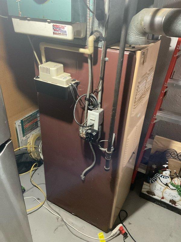 Conducted on-site assessment of existing HVAC system for replacement estimate. Inspected aging furnace and air conditioning equipment in basement mechanical room, noting deteriorated condition of both heating and cooling components with unknown service age. Documented current system configuration including air handler, ductwork connections, electrical panel wiring, and humidification equipment. Evaluated exterior condenser unit location and electrical service connections on building exterior. Photographed existing installation to determine proper sizing requirements and identify necessary modifications for new equipment installation. Provided comprehensive replacement quote for complete furnace and air conditioning system upgrade to meet immediate replacement needs.