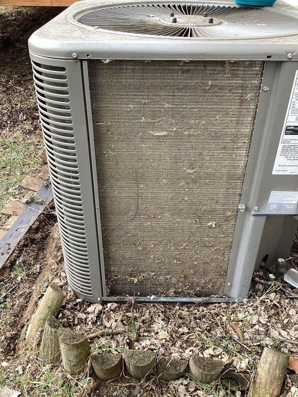 Completed annual cooling maintenance on residential air conditioning system. Performed visual inspection of outdoor condenser unit, noting significant accumulation of dirt, dust, and debris on heat exchanger coils requiring attention. Documented equipment condition and surrounding installation area showing outdoor weathering consistent with normal seasonal exposure.
