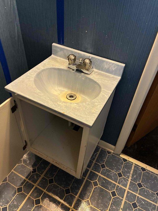 Installed new bathroom vanity faucet with dual-handle chrome fixture in powder room featuring decorative oval sink basin. Completed installation on white marble-pattern countertop, ensuring proper water supply connections and testing for leaks. Verified hot and cold water operation and confirmed all mounting hardware was secure.