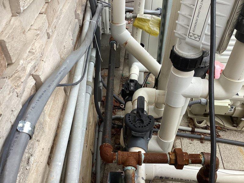 # Generator Maintenance Service

Performed routine maintenance service on a Generac 24kW standby generator unit. Conducted comprehensive system inspection including visual assessment of all mechanical components, electrical connections, and associated piping infrastructure. Verified proper operation of the generator control panel and confirmed all safety interlocks functioning correctly. Inspected the outdoor installation site, noting the generator's proximity to HVAC condensing unit and pool/spa circulation equipment. Examined associated PVC piping systems, valves, and support structures for proper installation and condition. Documented equipment condition through photographic records showing the complete installation setup, including the generator positioning on concrete pad, surrounding utility infrastructure, and related mechanical systems. All components found to be in satisfactory working condition with no immediate service requirements identified.