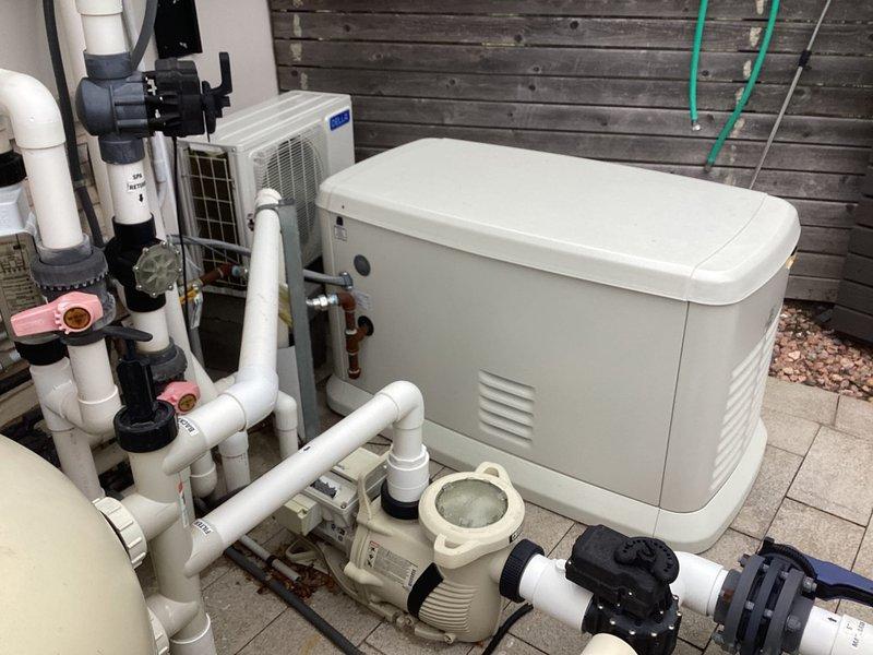 # Generator Maintenance Service

Performed routine maintenance service on a Generac 24kW standby generator unit. Conducted comprehensive system inspection including visual assessment of all mechanical components, electrical connections, and associated piping infrastructure. Verified proper operation of the generator control panel and confirmed all safety interlocks functioning correctly. Inspected the outdoor installation site, noting the generator's proximity to HVAC condensing unit and pool/spa circulation equipment. Examined associated PVC piping systems, valves, and support structures for proper installation and condition. Documented equipment condition through photographic records showing the complete installation setup, including the generator positioning on concrete pad, surrounding utility infrastructure, and related mechanical systems. All components found to be in satisfactory working condition with no immediate service requirements identified.