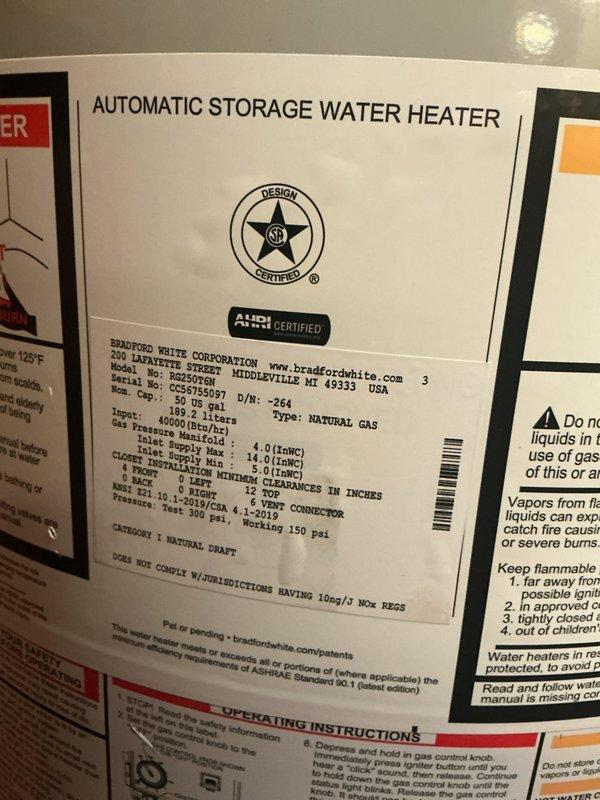 Installed a 50-gallon Bradford White automatic storage water heater (Model M3C5097) with 40,000 BTU/hr input rating in basement utility area. Connected copper supply and discharge piping to unit top with appropriate fittings and verified all gas connections per manufacturer specifications. Obtained required permits prior to installation and documented completed work with photographs showing proper clearances, labeling, and installation against concrete block wall foundation.