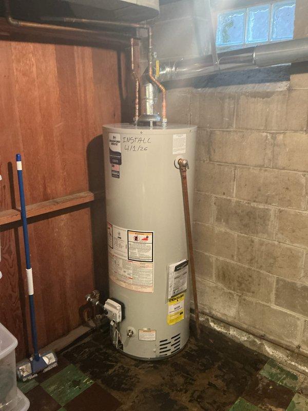 Installed a 50-gallon Bradford White automatic storage water heater (Model M3C5097) with 40,000 BTU/hr input rating in basement utility area. Connected copper supply and discharge piping to unit top with appropriate fittings and verified all gas connections per manufacturer specifications. Obtained required permits prior to installation and documented completed work with photographs showing proper clearances, labeling, and installation against concrete block wall foundation.