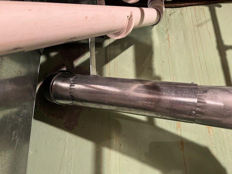 Provided estimate for replacement of non-functioning standard natural draft water heater in residential property. Assessed existing water heater installation including venting configuration, supply and discharge piping penetrations through utility area walls, and connection points. Documented current plumbing infrastructure with natural draft venting system to determine appropriate replacement specifications and installation requirements.