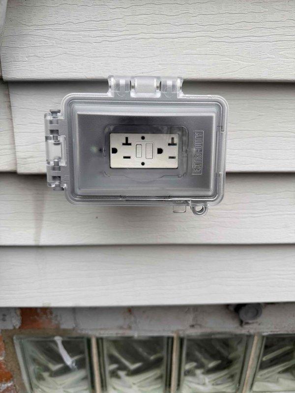 Completed recall to address code violations from recent HVAC installation of 70,000 BTU furnace with humidifier and 2-ton air conditioning unit. Installed weatherproof GFCI receptacle outlet on exterior siding within required 25-foot distance of outdoor condensing unit and added proper circuit identification labels to electrical panel to bring installation into compliance with electrical code requirements.
