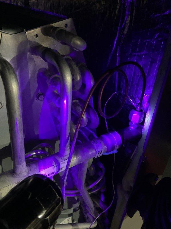 Performed initial leak search on A/C system using UV dye and lighting equipment to identify refrigerant leak points throughout evaporator coil assembly and associated refrigerant lines. Inspected condenser unit, refrigerant piping connections, and mechanical components for visible signs of refrigerant loss. Second visit required to complete comprehensive leak detection and determine full scope of necessary repairs.