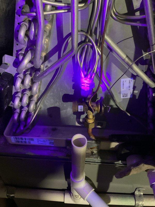 Performed initial leak search on A/C system using UV dye and lighting equipment to identify refrigerant leak points throughout evaporator coil assembly and associated refrigerant lines. Inspected condenser unit, refrigerant piping connections, and mechanical components for visible signs of refrigerant loss. Second visit required to complete comprehensive leak detection and determine full scope of necessary repairs.