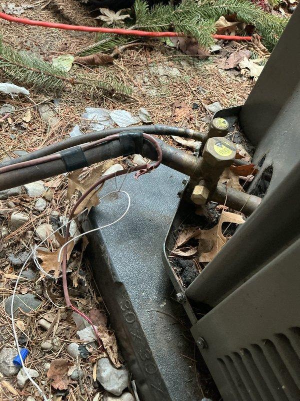 # HVAC Service Report

Responded to no-cooling complaint on one-year-old air conditioning system. Upon arrival, discovered severe electrical failure at outdoor unit with extensive heat damage to wiring and electrical components. Found melted and charred wiring harness, indicating catastrophic electrical short or overload condition. Inspected electrical panel box and internal connections, noting damaged conductors and compromised circuit protection components. Evaluated refrigerant line connections showing corrosion at fittings, though refrigerant circuit integrity remained intact. Documented extensive thermal damage to electrical infrastructure requiring complete replacement of affected wiring, connectors, and control components. System remains under parts and labor warranty coverage. Unit secured and made safe pending parts procurement and complete electrical system restoration.