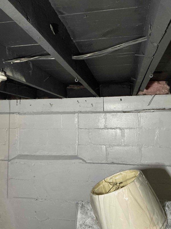 Conducted comprehensive assessment of non-functional air conditioning unit in basement mechanical room for complete system replacement estimate. Evaluated existing natural gas furnace installation, ductwork configuration, and gas line infrastructure with yellow-handled shutoff valve to determine equipment compatibility and replacement requirements. Documented current HVAC system layout including metal ductwork routing, structural clearances, and utility connections to provide accurate equipment sizing and installation specifications for new AC unit replacement.