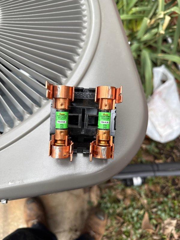 Responded to recall for violation repairs on Lennox condenser unit. Upon arrival, confirmed AC disconnect was missing required fuses, creating a safety hazard and code violation. Installed proper copper cylindrical fuses in the black fuse block disconnect, securing them with appropriate metal clips. Verified electrical connections, tested unit operation, and confirmed all safety components now meet code requirements.