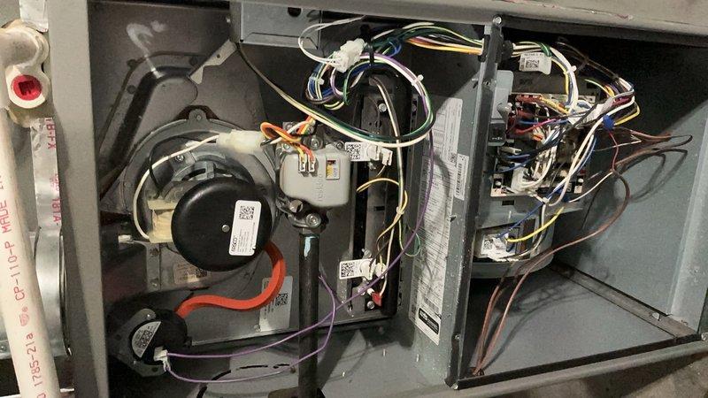 Completed comprehensive ComfortGuard Maintenance Package on a three-year-old forced air furnace and air conditioning system. Performed full AC tune-up including inspection of blower motor assembly, electrical connections, and control board components. Verified all wire connections were secure with proper color-coded terminations, inspected motor windings and capacitor, checked refrigerant lines and drainage system, and tested all electrical controls for proper operation. Removed access panels to examine internal components, confirmed blower assembly functioning correctly with no unusual wear or debris accumulation. Inspected control board for any signs of overheating or component failure, verified all safety switches and relays operating within specifications. Checked all wire harnesses and connectors for signs of deterioration or loose connections. System operating at optimal performance with no deficiencies noted; all components within manufacturer specifications and ready for contin