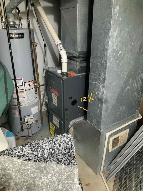 Assessed 19-year-old Goodman furnace system with failed heat exchanger in basement mechanical room. Documented existing equipment configuration including furnace, water heater, ductwork, and venting system. Provided comprehensive full system replacement estimate for new HVAC equipment due to heat exchanger failure requiring immediate replacement.