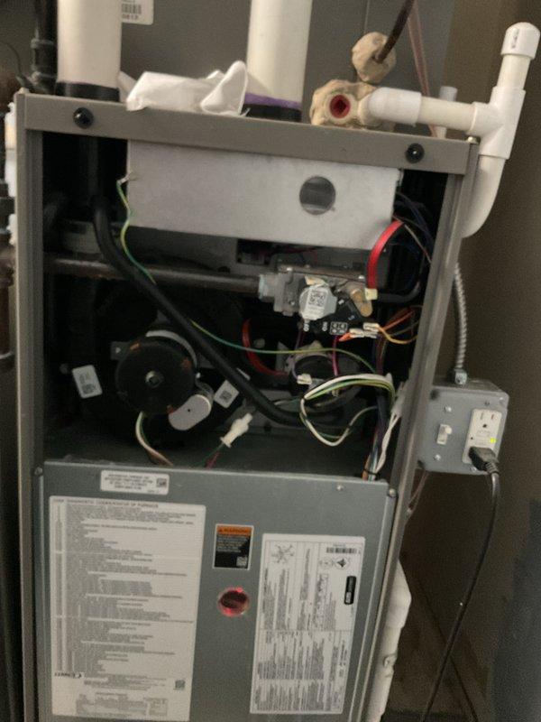 Completed annual heating maintenance on residential furnace unit as part of preventative membership service. Performed comprehensive tune-up inspection with front access panel removed to access internal components. Inspected blower motor assembly, electrical connections, and control boards for proper operation and wear. Verified all color-coded wiring connections secure throughout system. Examined PVC condensate drain and venting system for proper installation and function. Checked electrical junction box and safety switches. All components found in normal operating condition with no deficiencies noted. Unit tested and confirmed ready for heating season.