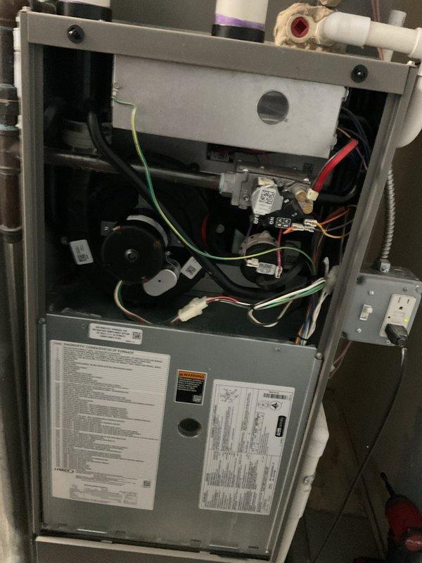 Completed annual heating maintenance on residential furnace unit as part of preventative membership service. Performed comprehensive tune-up inspection with front access panel removed to access internal components. Inspected blower motor assembly, electrical connections, and control boards for proper operation and wear. Verified all color-coded wiring connections secure throughout system. Examined PVC condensate drain and venting system for proper installation and function. Checked electrical junction box and safety switches. All components found in normal operating condition with no deficiencies noted. Unit tested and confirmed ready for heating season.