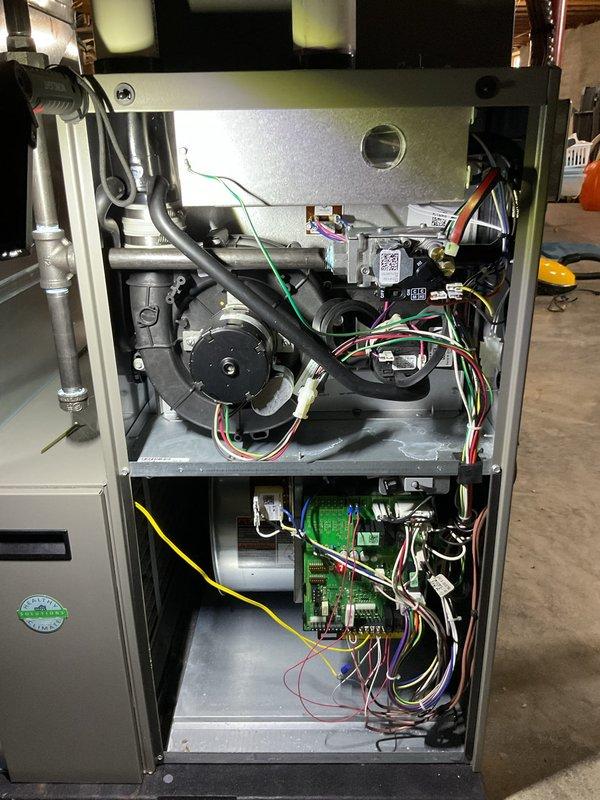 # HVAC Maintenance - ComfortGuard Maintenance - Furnace

Performed comprehensive annual tune-up and preventive maintenance on residential furnace unit under existing five-year post-installation contract with no customer-reported operational issues. Accessed internal components by removing cabinet panels to inspect blower motor assembly, electrical connections, control board, and gas valve systems. Verified proper wire terminations and connections throughout system, including thermostat wiring with standard color-coding (red, yellow, green, white, black, purple). Inspected blower motor operation and associated flexible ductwork connections. Examined green circuit board for signs of wear or damage and confirmed secure mounting and wire routing. Checked all safety controls and electrical components for proper function. Cleaned accessible interior surfaces and components as part of routine maintenance protocol. Confirmed system operational readiness and documented furnace condition with ph