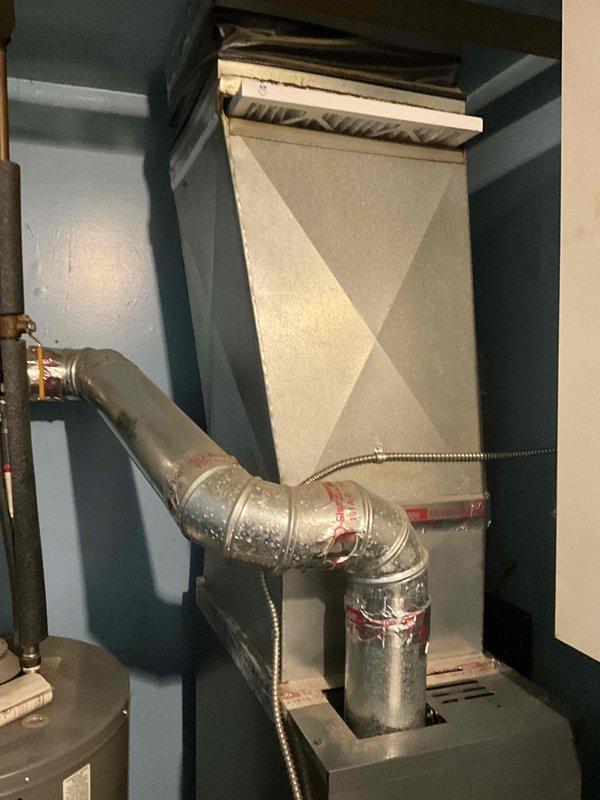 Completed full system estimate for replacement of existing HVAC equipment including 10-year-old Goodman furnace and 16-year-old air conditioning system. Inspected current installation in basement mechanical room, documented existing equipment configuration including furnace, ductwork connections, and plenum assembly. Photographed equipment to assess installation requirements and provided comprehensive quote for new furnace and AC system replacement, as customer's air conditioning unit barely functioned through previous cooling season and requires replacement within the month.