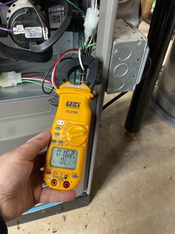 Performed complimentary maintenance on forced air furnace and air conditioning system. Conducted comprehensive AC tune-up including electrical diagnostics using digital multimeter to verify voltage readings at 216.2V and amperage draw measurements showing 0.0A on system components. Inspected all electrical connections, motor assembly, and internal cabinet components for proper operation. System found to be functioning correctly with no issues identified during inspection. All components tested within normal operating parameters.
