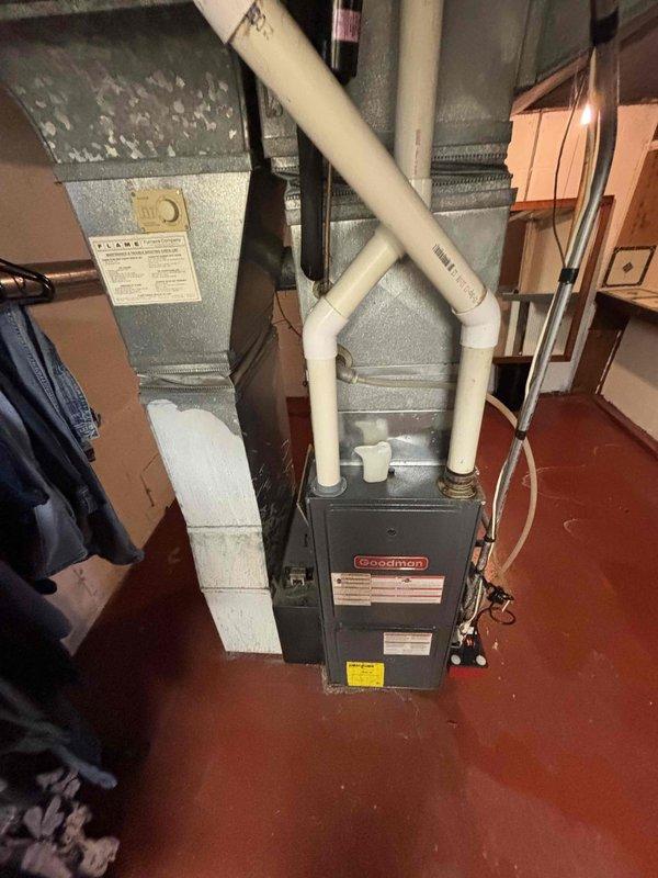 Completed full HVAC system estimate for residential property with 15-year-old air conditioning unit and furnace requiring evaluation. Assessed existing Goodman furnace installation in basement with current PVC condensate drainage and ventilation piping, along with connected ductwork and air handler components. Evaluated outdoor condensing unit positioned on exterior brick wall foundation, noting electrical disconnect and refrigerant line set configuration. Provided comprehensive replacement options for aging air conditioning system and repair recommendations for furnace to address homeowner's request for system upgrade within current season.