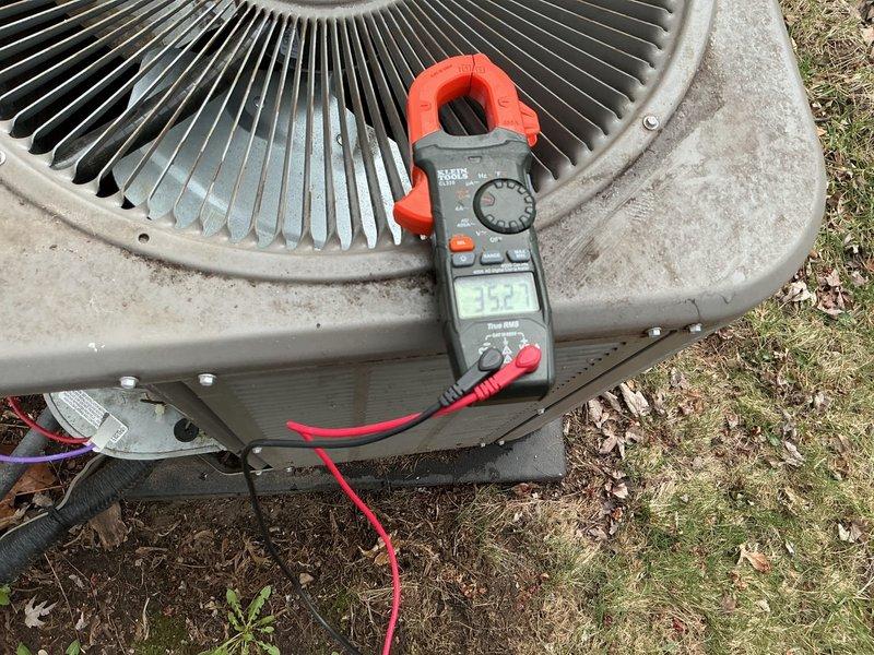 Completed comprehensive 5-year ComfortGuard maintenance visit on residential HVAC system. Performed electrical diagnostics on outdoor condenser unit using clamp meter to verify proper amperage draw and system performance. Inspected condenser coils, fan operation, and overall unit condition. Verified thermostat functionality and temperature calibration, confirming system maintained proper cooling setpoints with digital display reading 67°F and operating in automatic mode. All components tested within normal operating parameters and system found to be functioning efficiently.