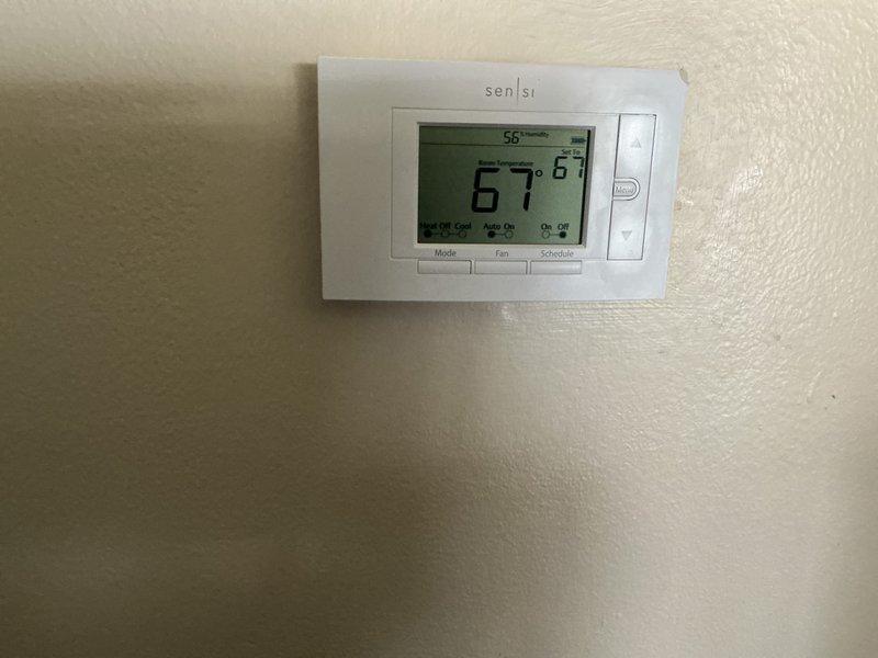 Completed comprehensive 5-year ComfortGuard maintenance visit on residential HVAC system. Performed electrical diagnostics on outdoor condenser unit using clamp meter to verify proper amperage draw and system performance. Inspected condenser coils, fan operation, and overall unit condition. Verified thermostat functionality and temperature calibration, confirming system maintained proper cooling setpoints with digital display reading 67°F and operating in automatic mode. All components tested within normal operating parameters and system found to be functioning efficiently.