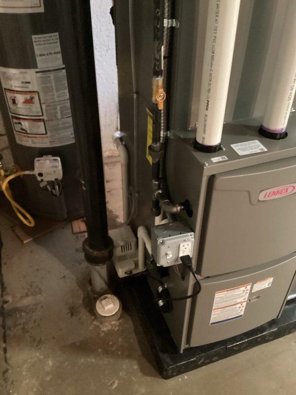 Completed full HVAC system installation including a 70,000 BTU Lennox furnace with rear return configuration and 2-ton air conditioning unit. Installed furnace on platform with proper venting using white PVC piping, reconnected all gas lines and electrical connections, and integrated humidifier into system. Ensured plenum front was properly flattened after rotation to achieve correct orientation for optimal airflow and system performance.