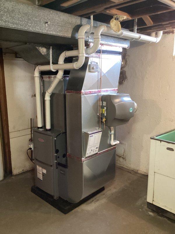 Completed full HVAC system installation including a 70,000 BTU Lennox furnace with rear return configuration and 2-ton air conditioning unit. Installed furnace on platform with proper venting using white PVC piping, reconnected all gas lines and electrical connections, and integrated humidifier into system. Ensured plenum front was properly flattened after rotation to achieve correct orientation for optimal airflow and system performance.