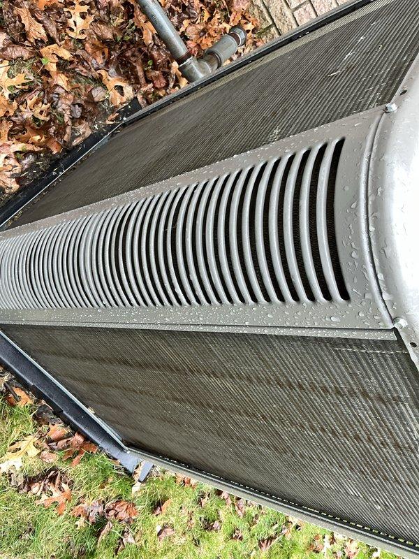 Completed routine Air Care Maintenance on residential outdoor HVAC unit. Performed comprehensive inspection of condenser coil, which showed clean fins in good condition with proper spacing and no debris buildup. Verified unit operational status, checked refrigerant lines, and confirmed proper drainage system function. All components operating within normal parameters with no service issues identified.